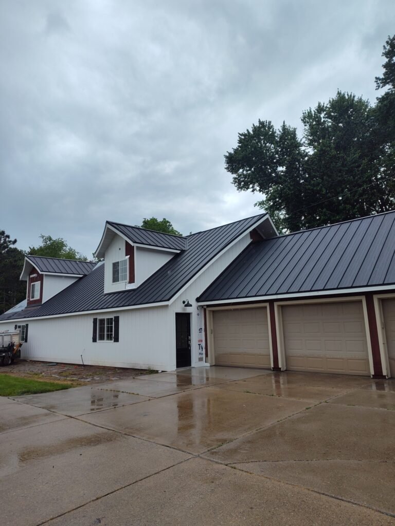 A new black metal roof installed on a Montana home by a construction contractor